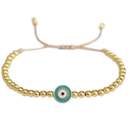 Love Ibiza armband. Gouden kralen met blauw evil eye 